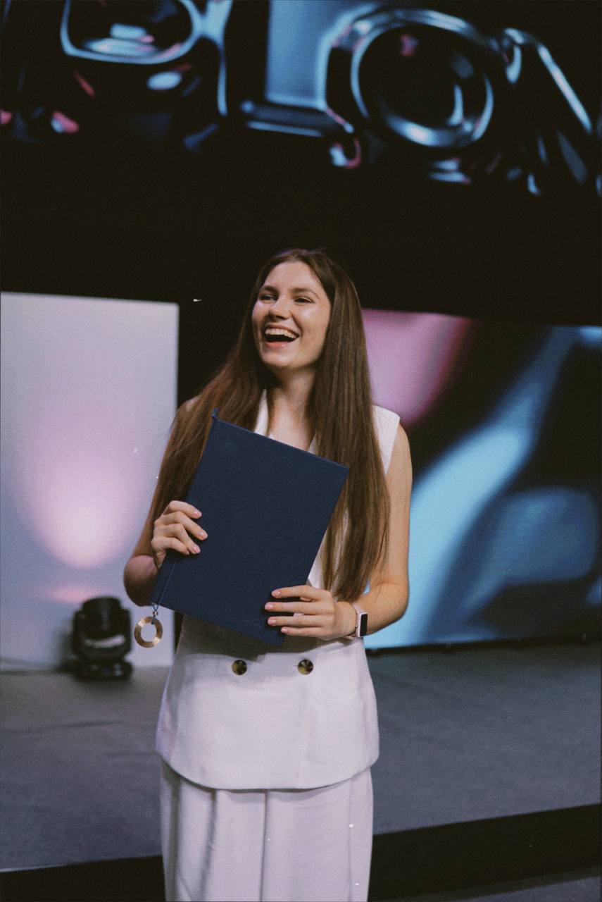 Diana holding diploma
